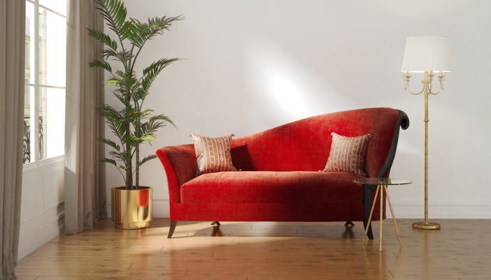 A red velvet chaise in a modern living room.