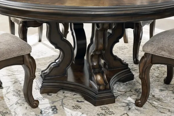 A close-up at the base of the Signature Design by Ashley Maylee pedestal table