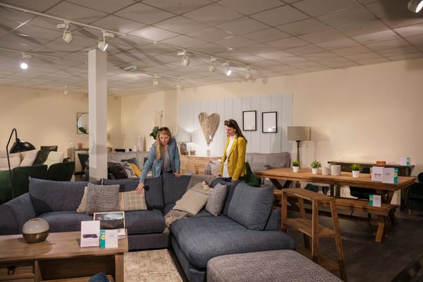 Woman inspecting sofas in a furniture showroom 