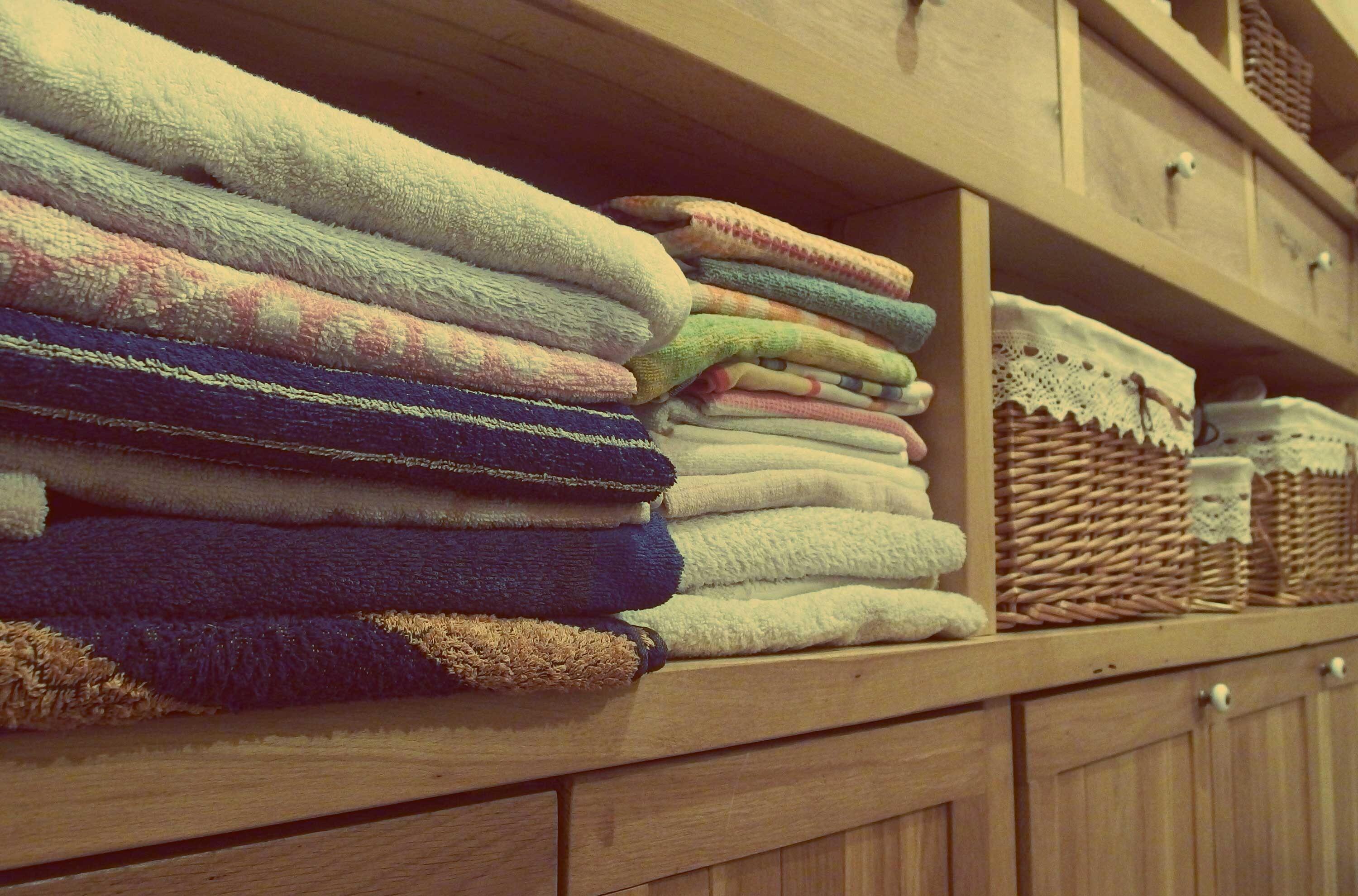 Stacked laundry on top of a shelf