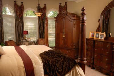 A bedroom featuring traditional wooden furniture 