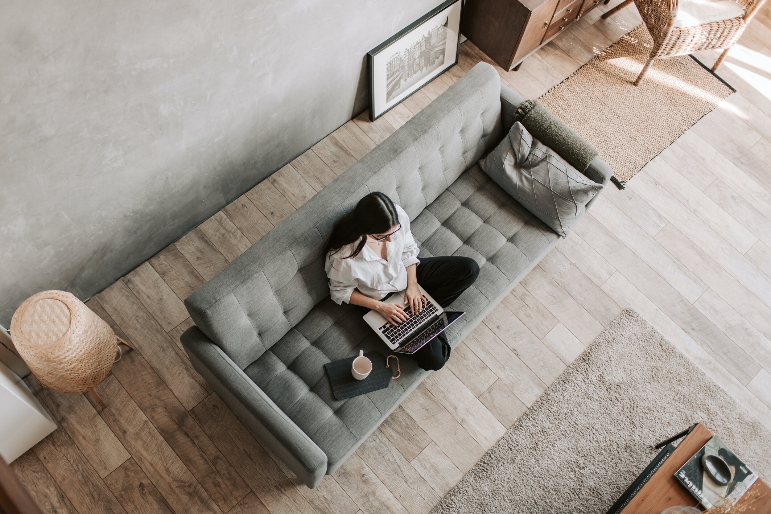Woman looking at laptop on couch