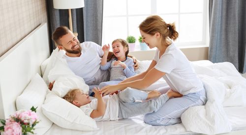 Family Together on a Bed Family Playing on a Bed