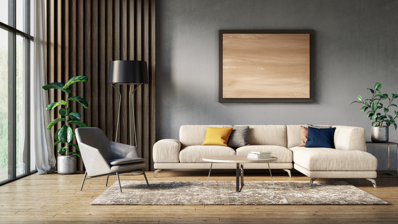Neutral painting and black lamp with a cream sofa