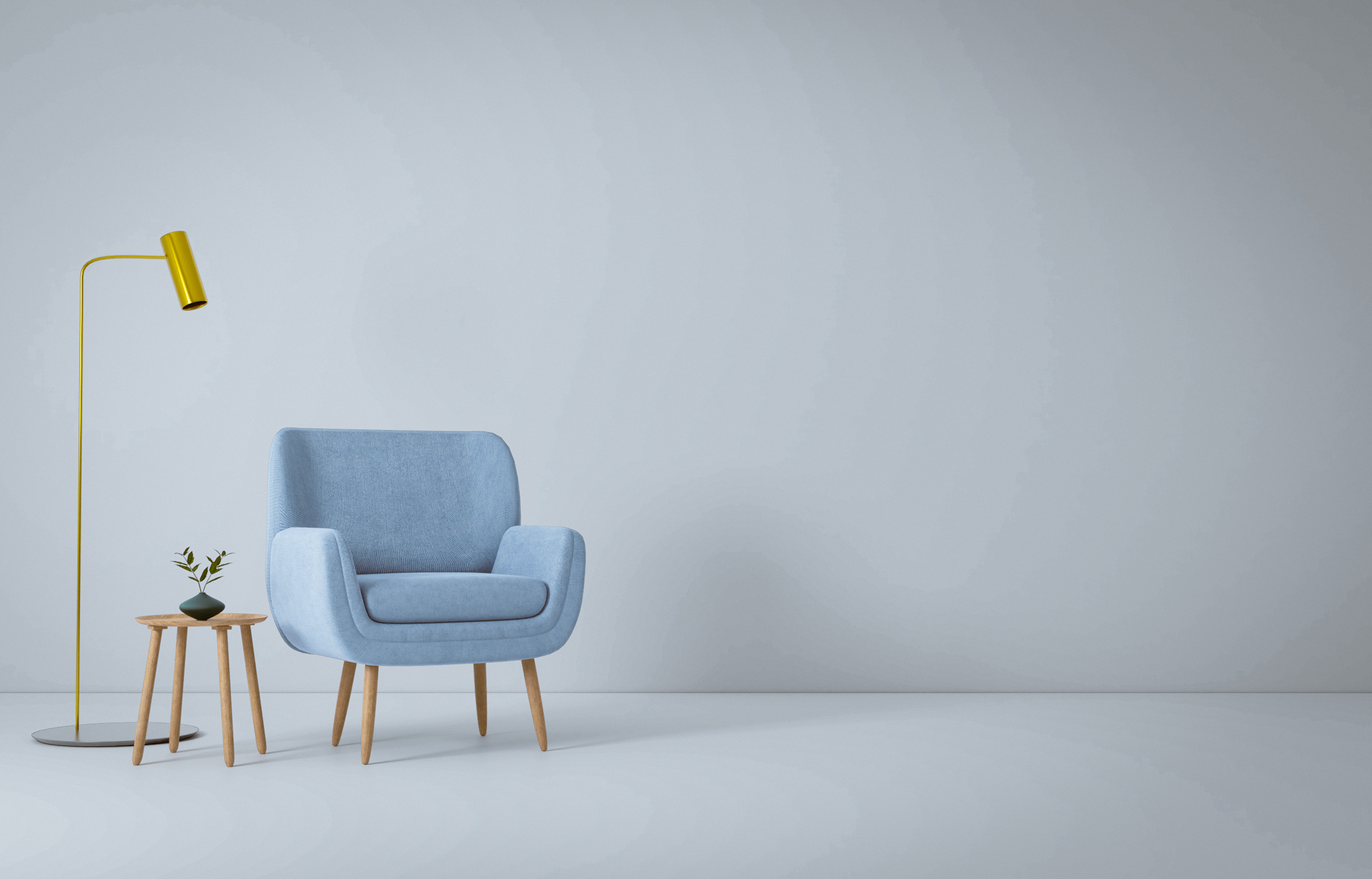 A blue living room accent chair and gold lamp against a gray background