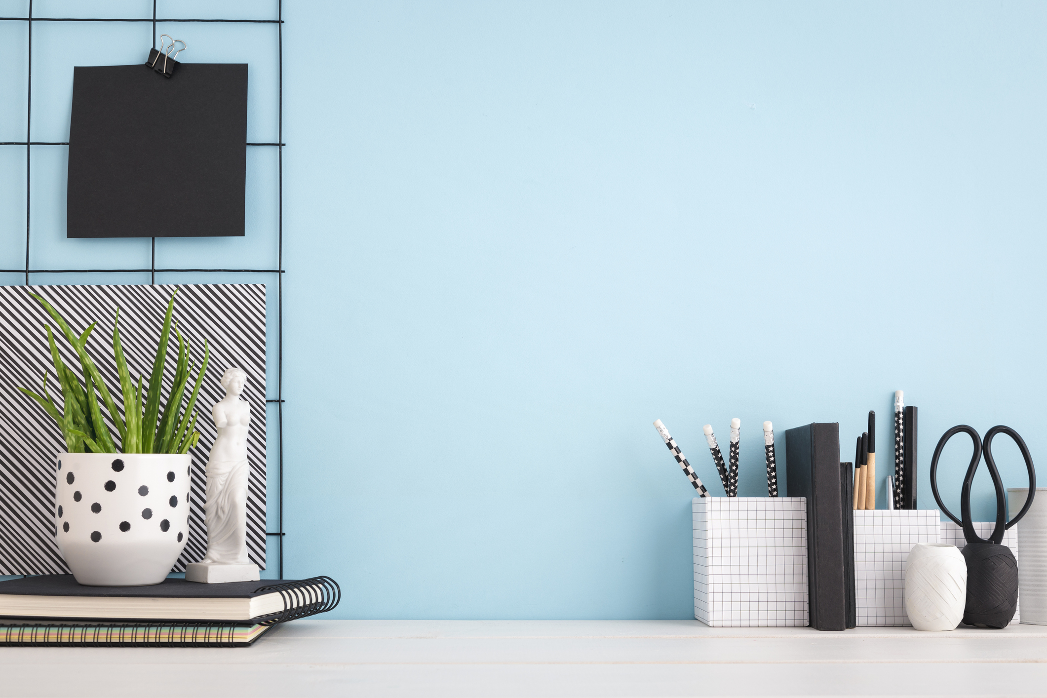 Desk designed with decor in a theme of blue, black, white stripes, and dots