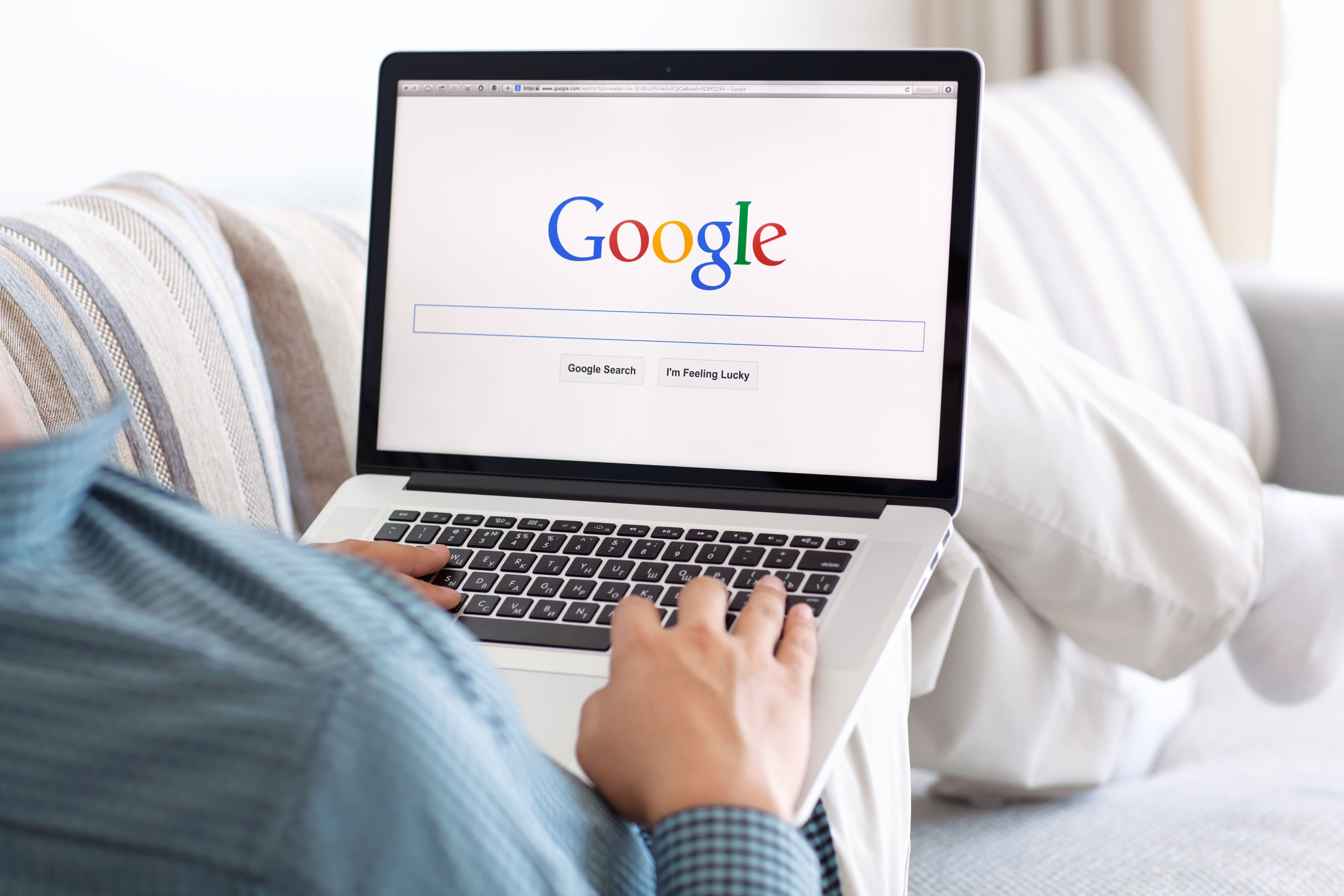 A person using Google search on a laptop