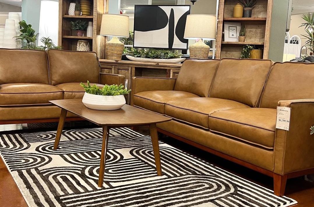 A leather sofa and loveseat set featured at a BlvdHome showroom 