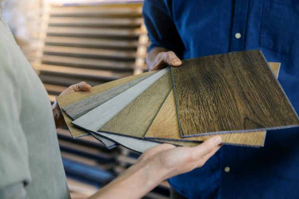A person reviewing samples of laminate flooring 