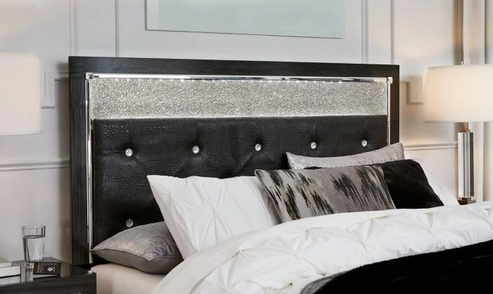 The Signature Design by Ashley Kaydell upholstered headboard with black and white bedding 