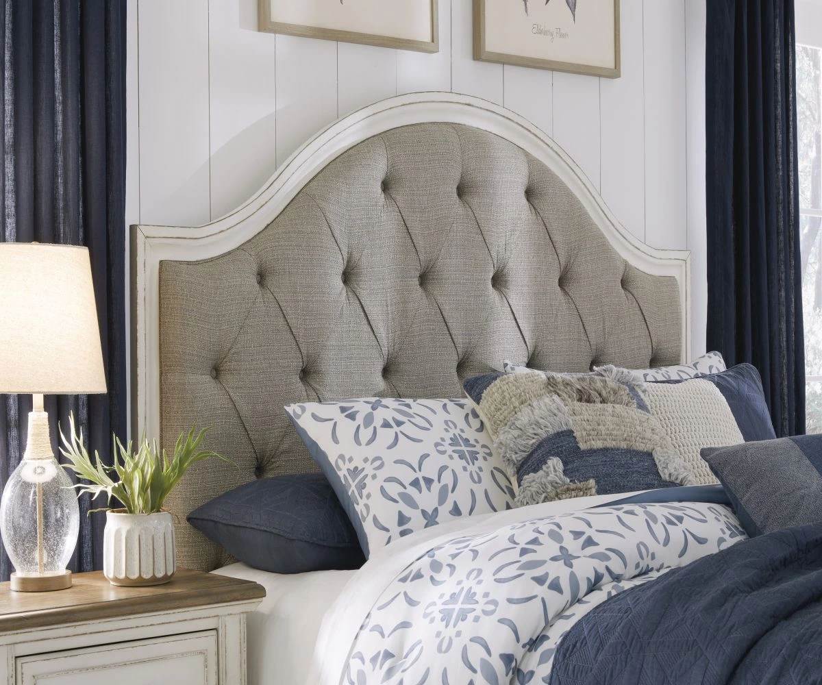 The Signature Design by Ashley Brollyn collection camel back tufted headboard with blue and white bedding 