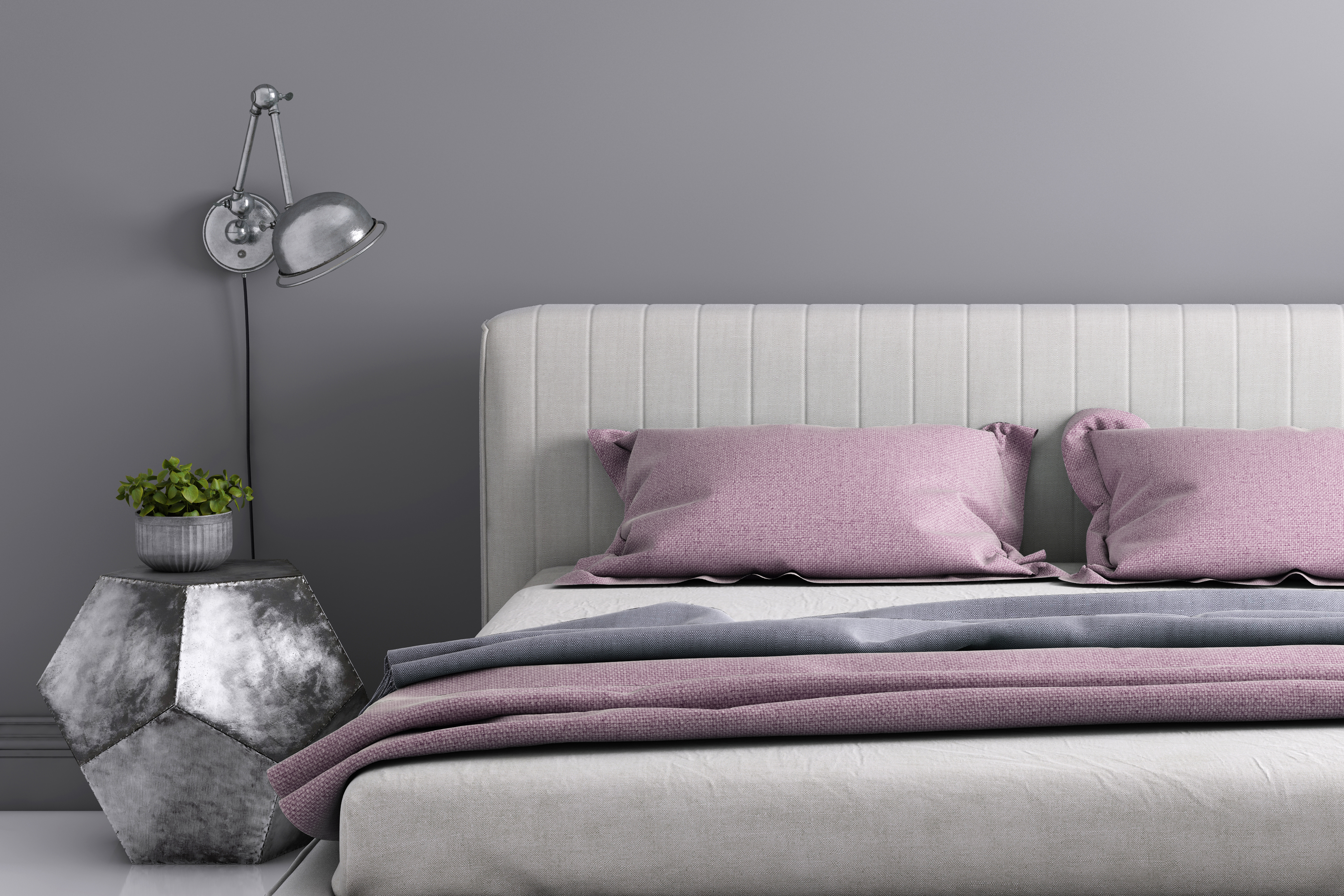 A grey vertical tufted upholstered headboard with purple pillows 