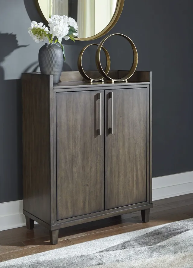 The Signature Design by Ashley Wittland bar cabinet in a blue-themed dining room 