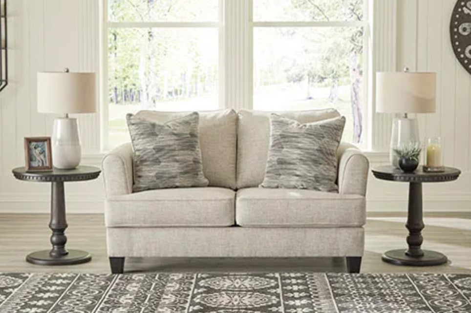 Linen sofa loveseat in a brightly lit living room.