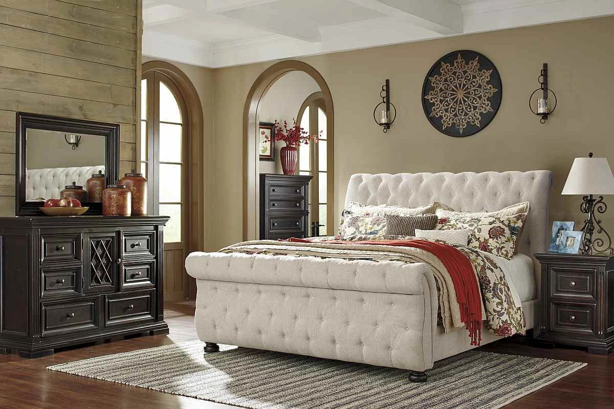 Linen queen upholstered bed is featured in a bedroom