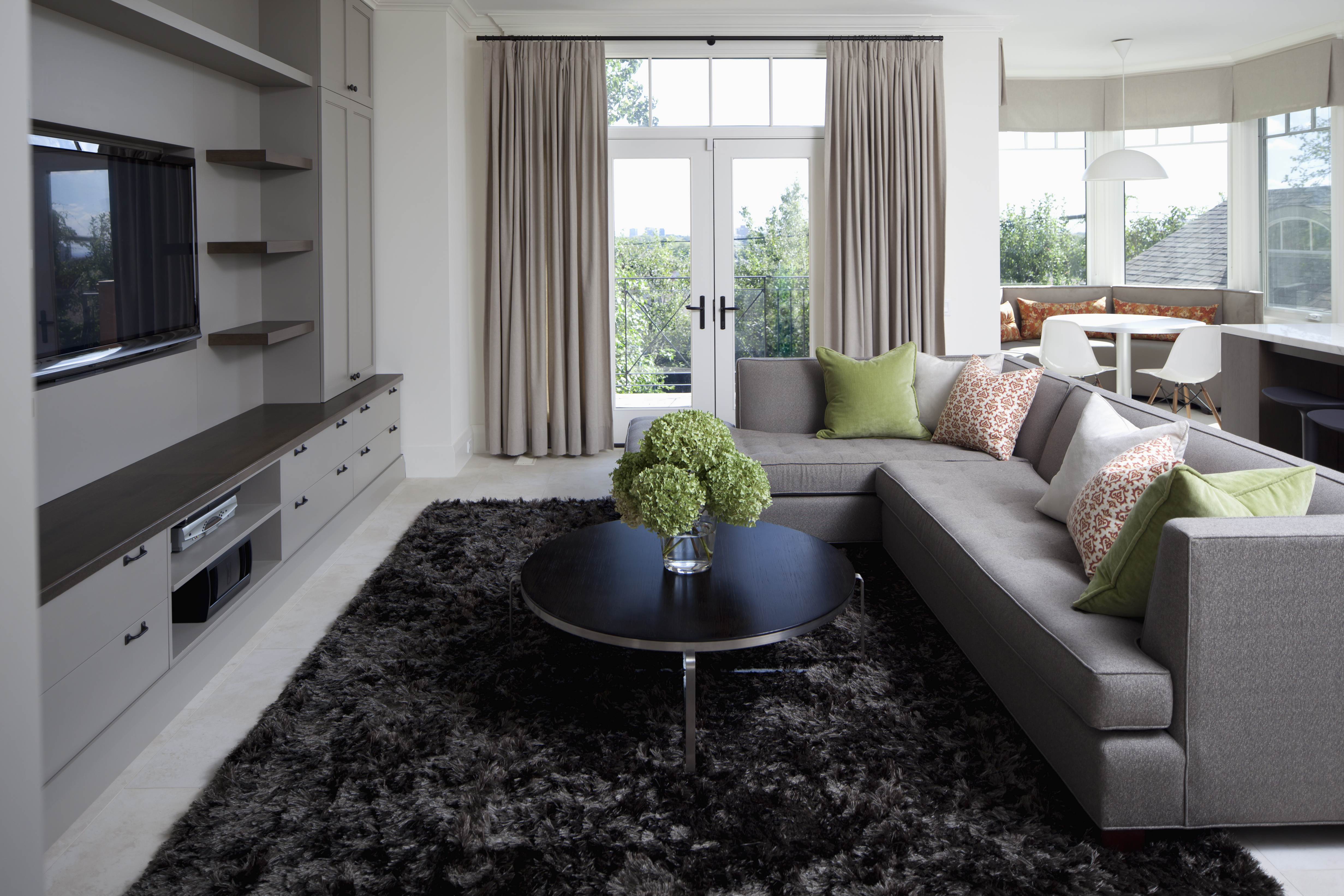 A grey L-shaped sofa in a living room with French doors 