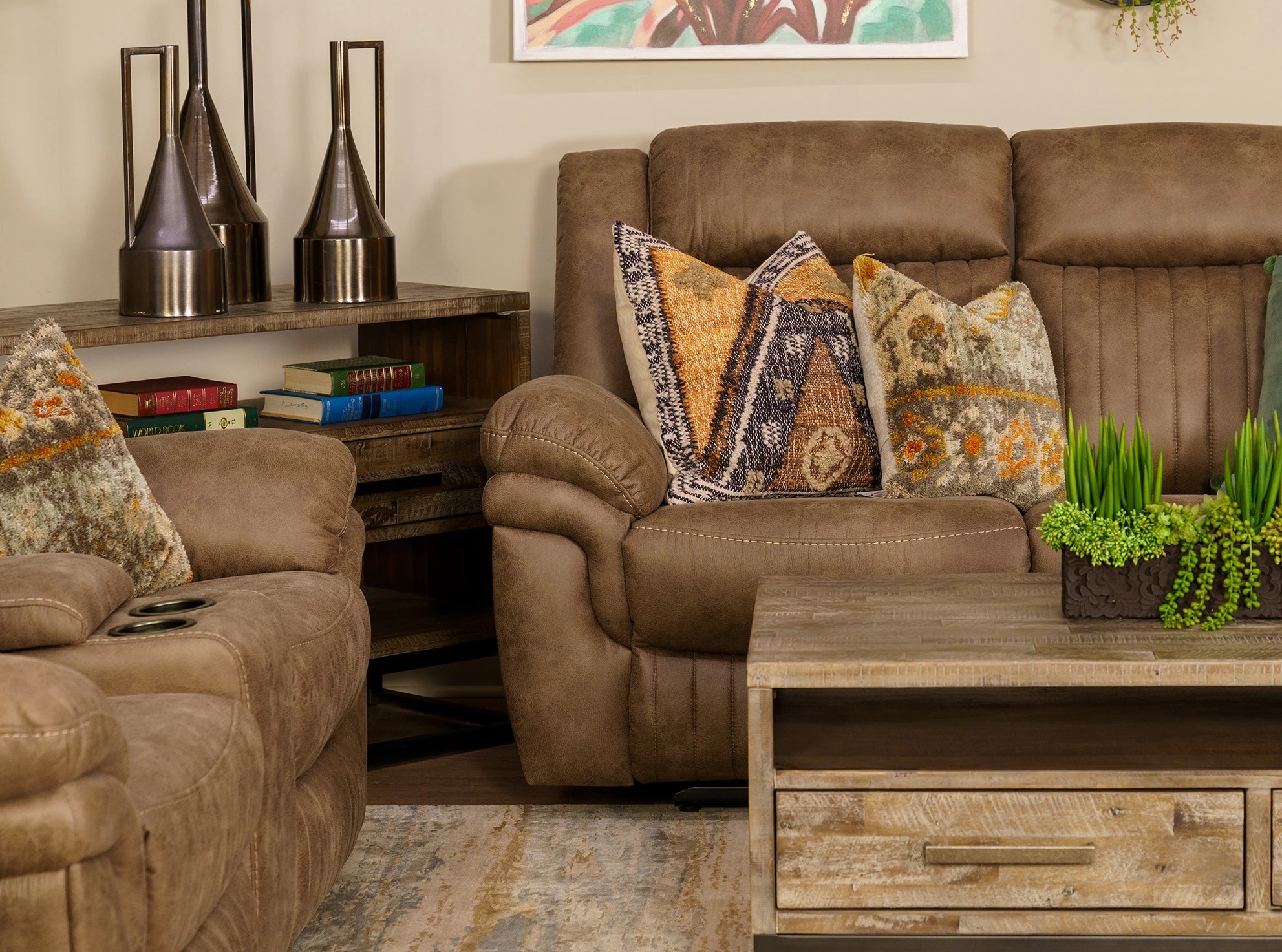 Caselli Gabrielle reclining sofa shown with decorative throws in a modern rustic living room 