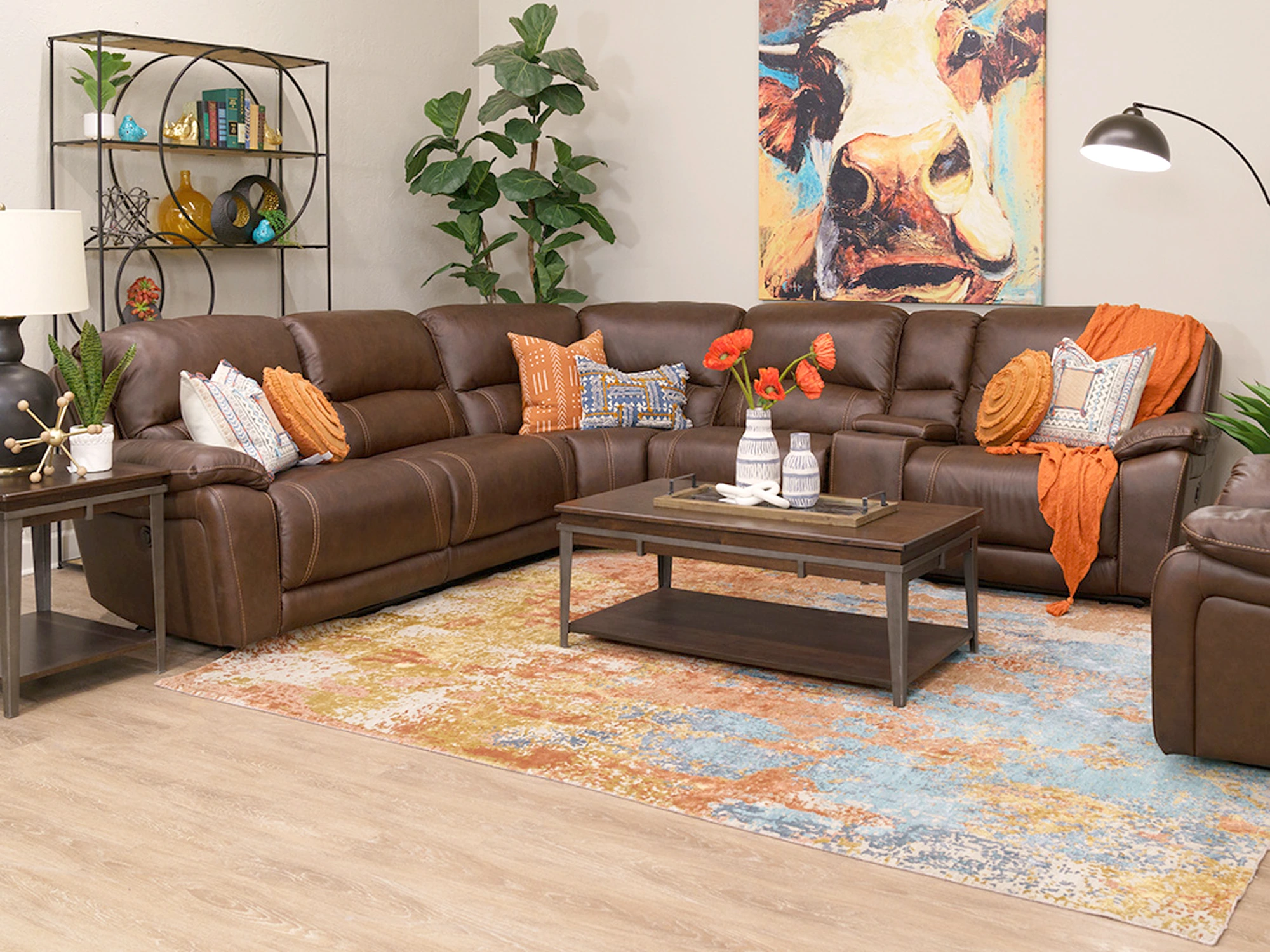 The Caselli Poppy power reclining leather sectional shown in a rustic living room 