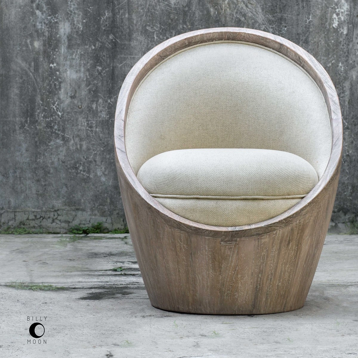 The Uttermost Noemi accent egg chair shown against a grey wall 