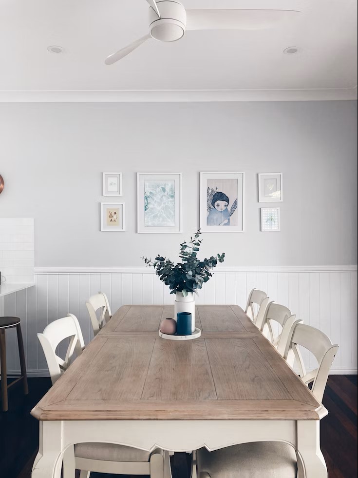 A farmhouse style dining table and wall art