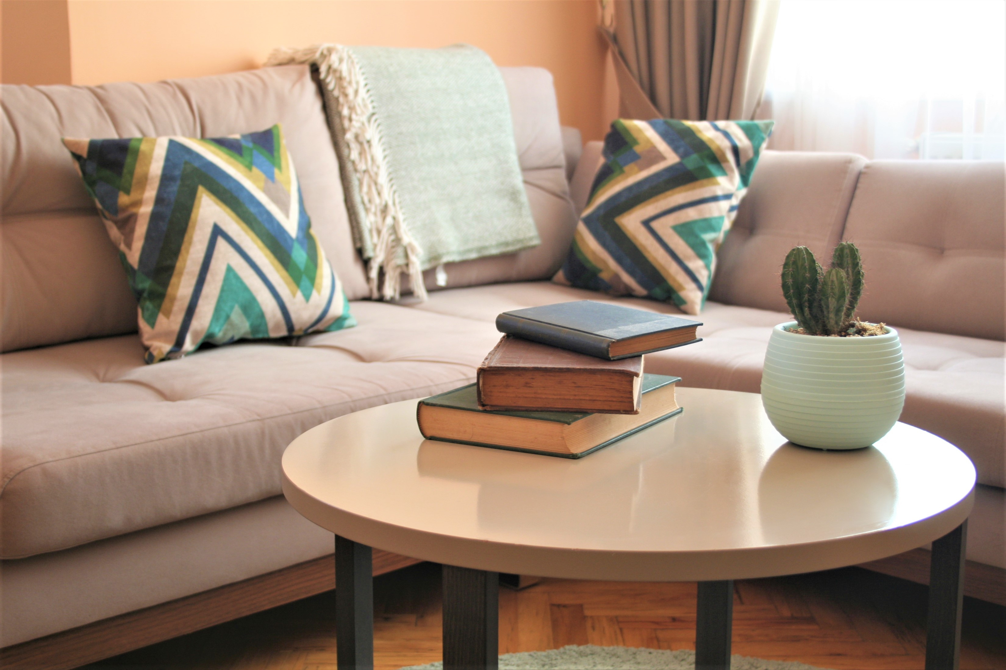 A round coffee table with earth tone furniture and décor 