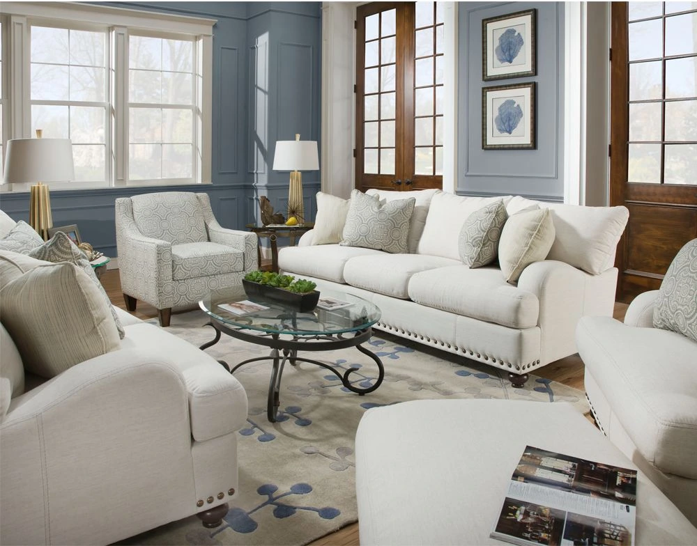 White sofa set is arranged in a blue living room