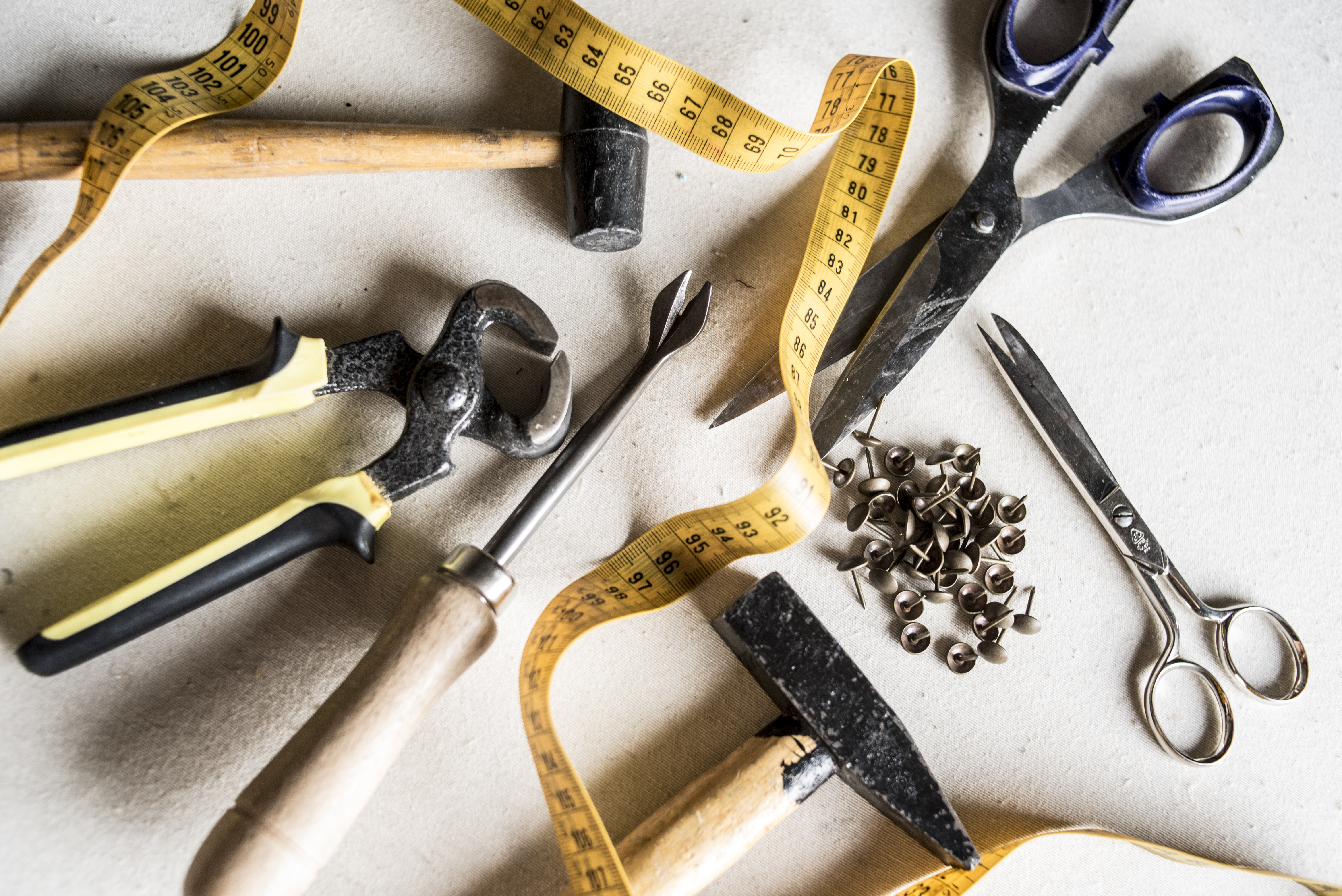 A collection of reupholstery tools
