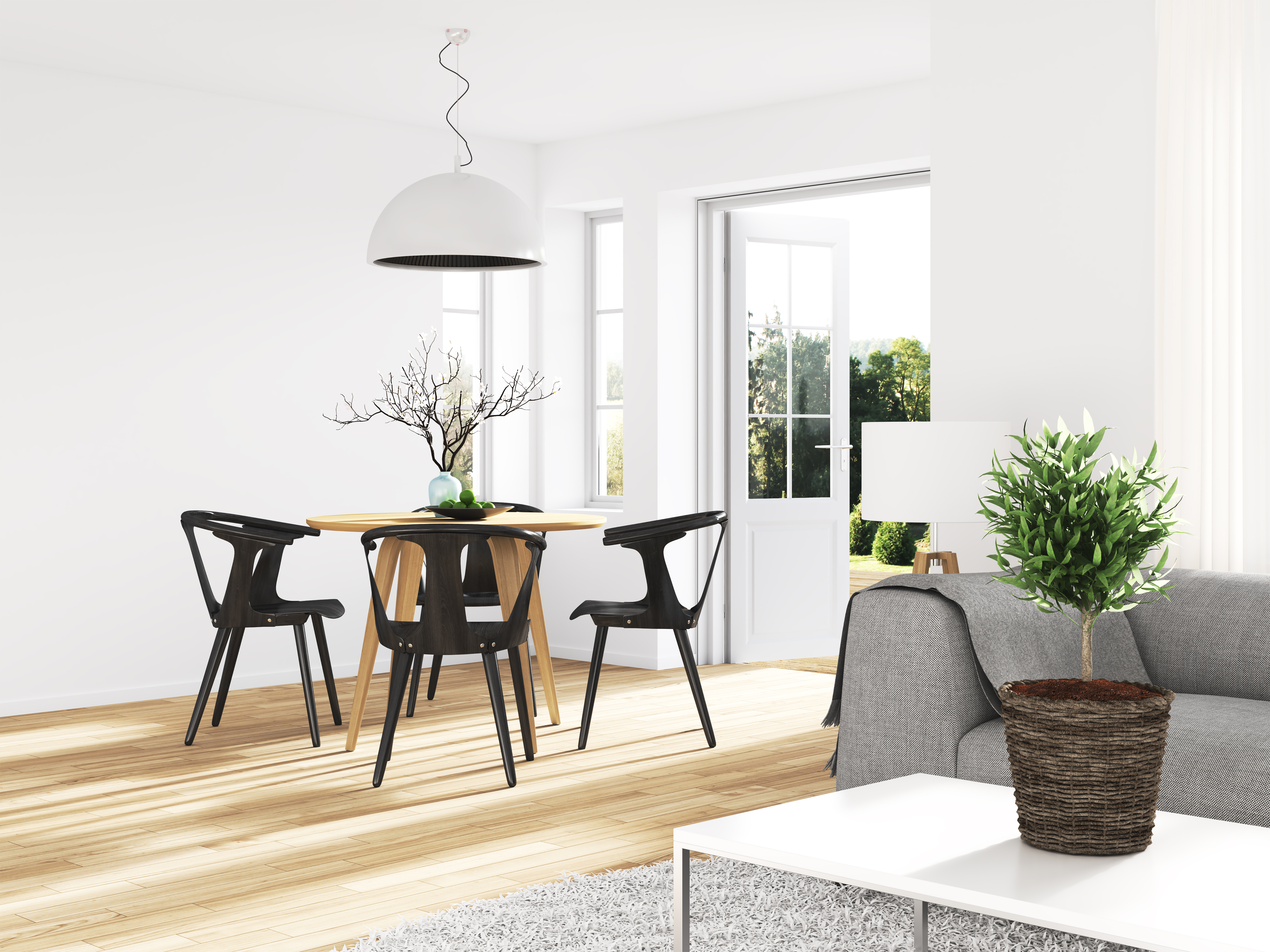 Long shot of a modern dining room with a  wooden table and black chairs 