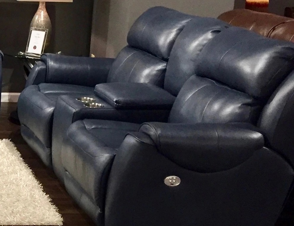 A home theater set up with navy recliners