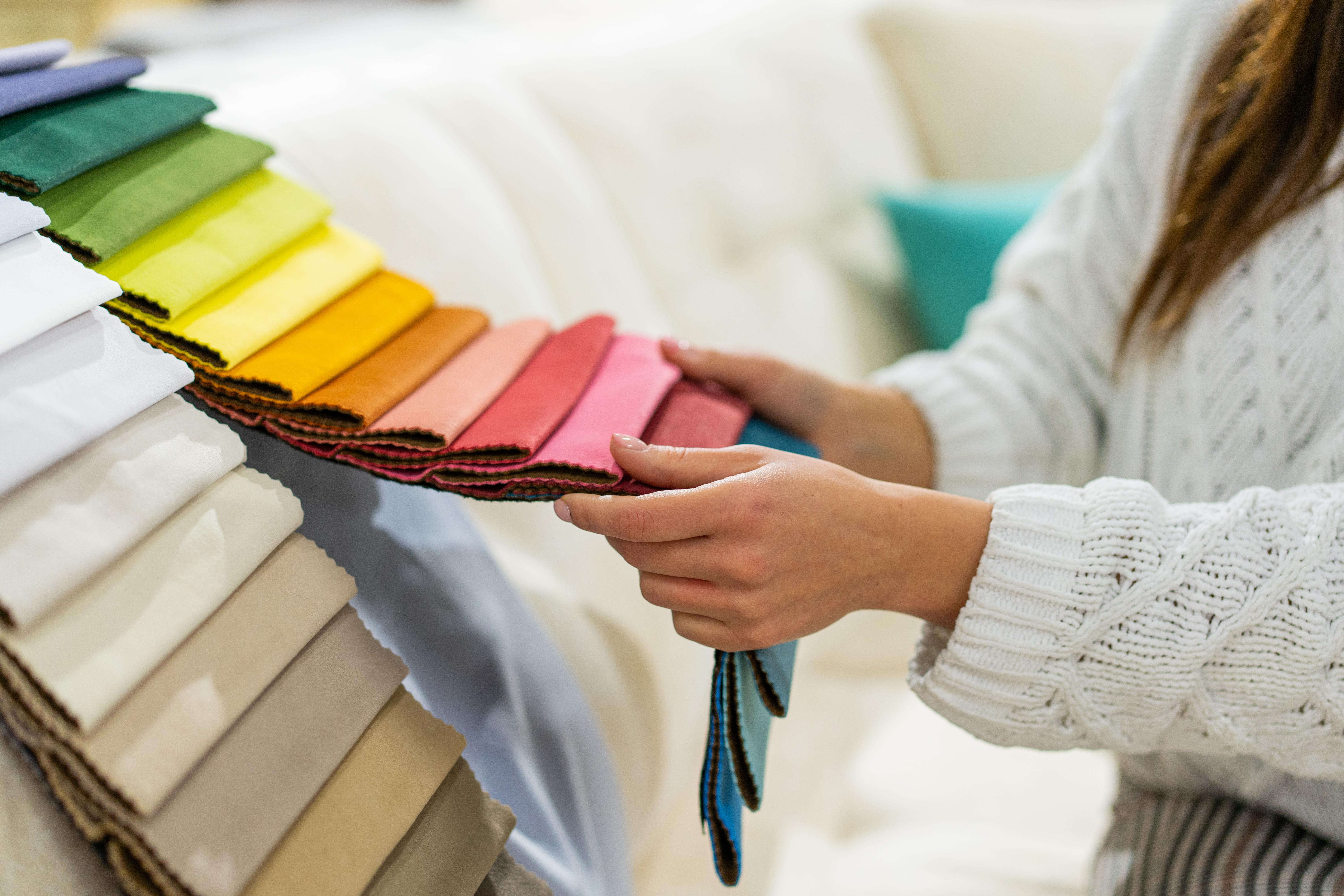 A woman reviewing upholstery samples in various colors 