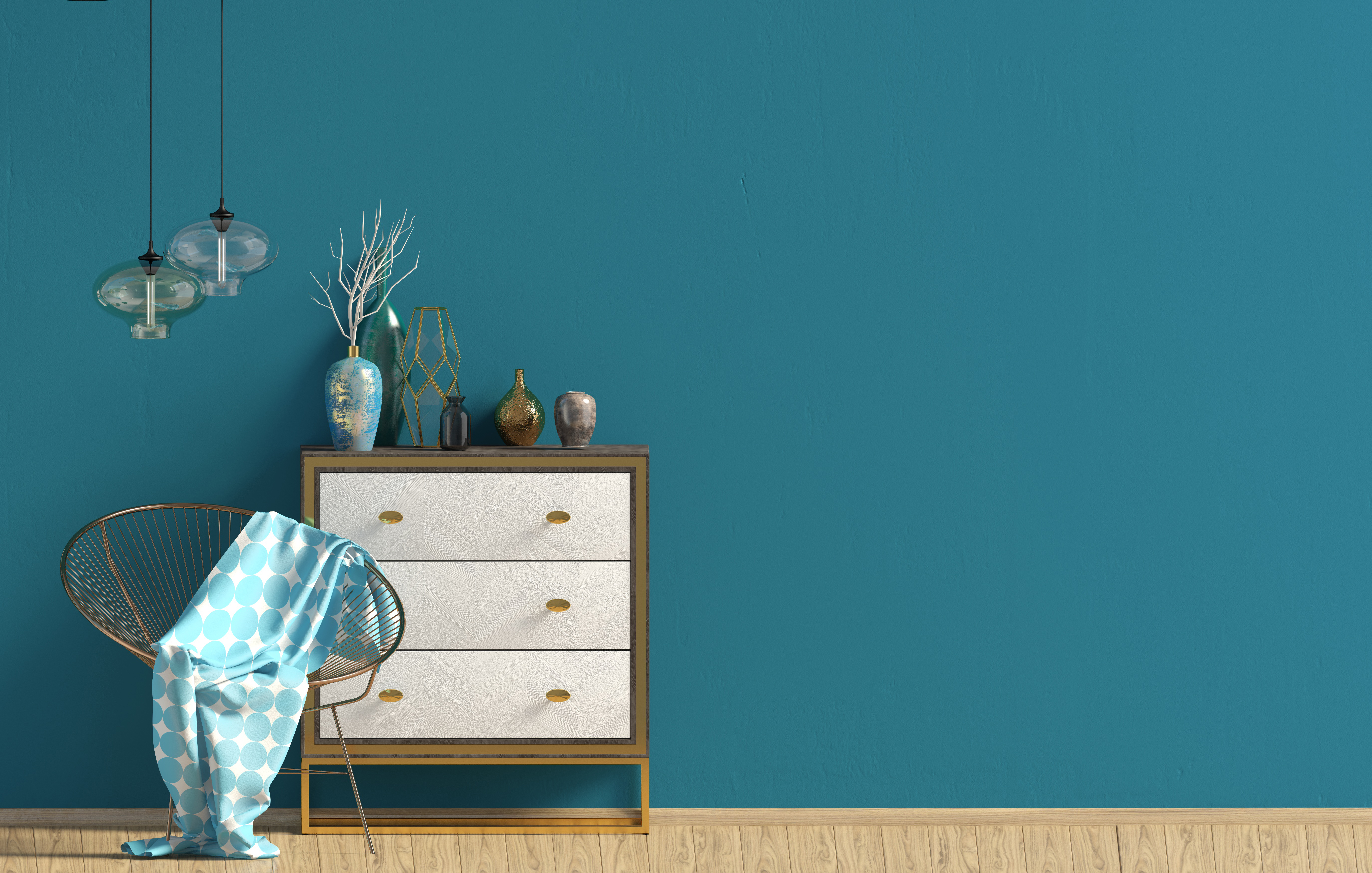 A white three-drawer dresser against a teal wall 