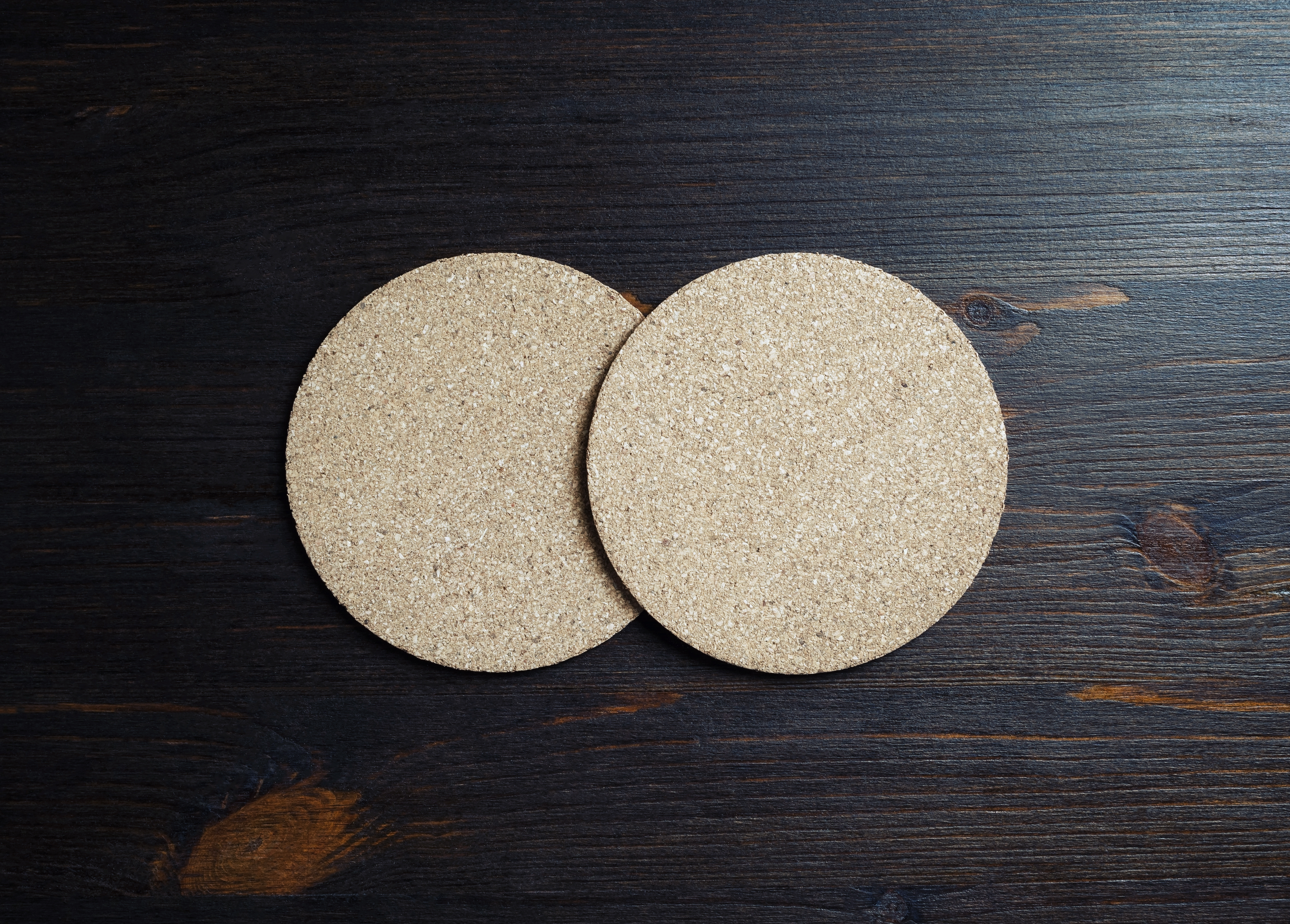 Overhead of coasters on a wooden surface 