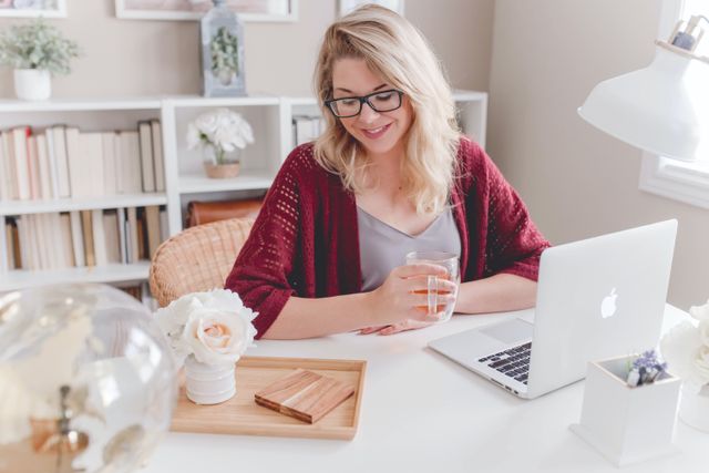 Front view of a woman sitting at her organized writing desk