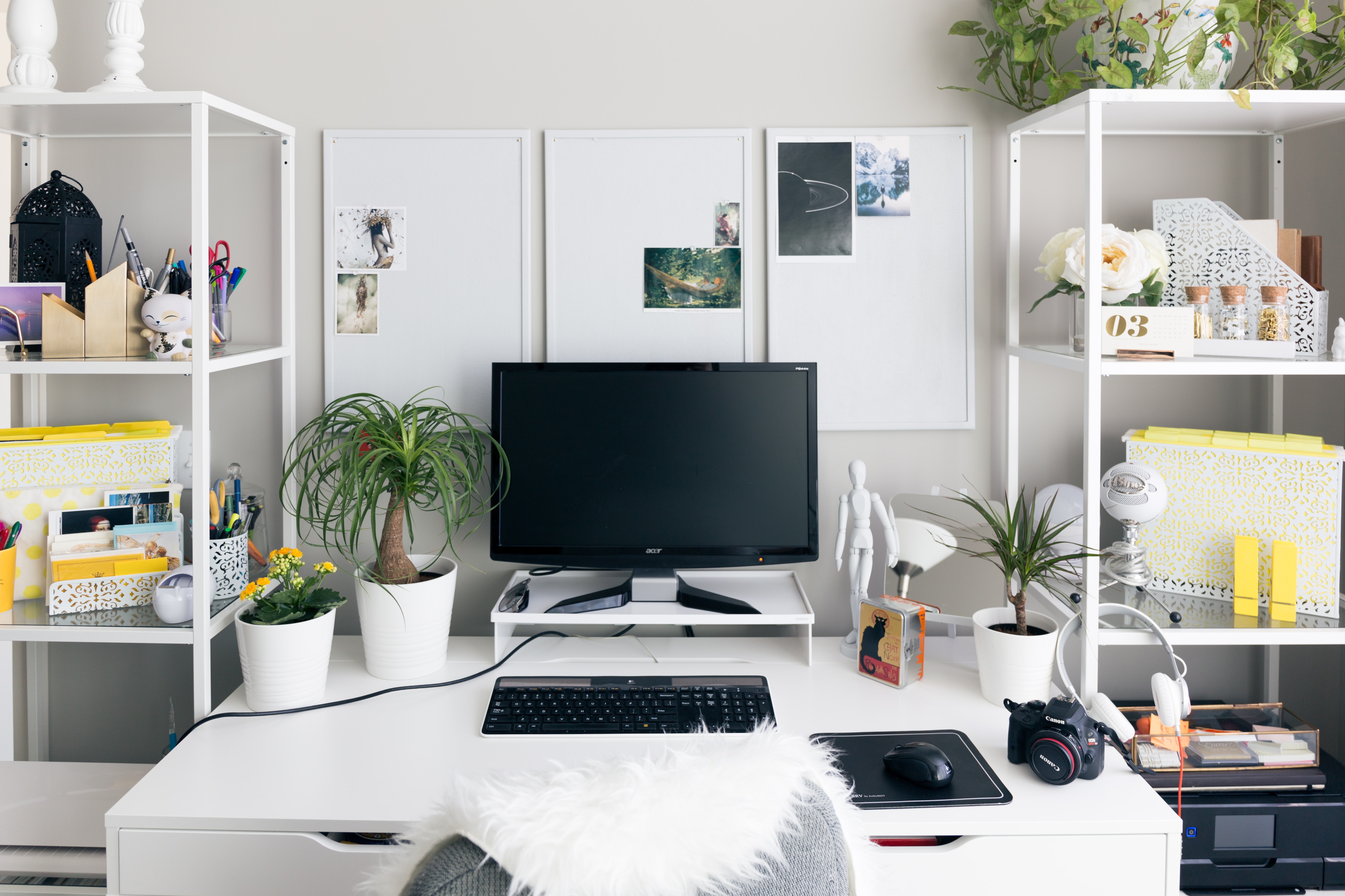 a glamorous home office with whiteboards and photographs on the wall