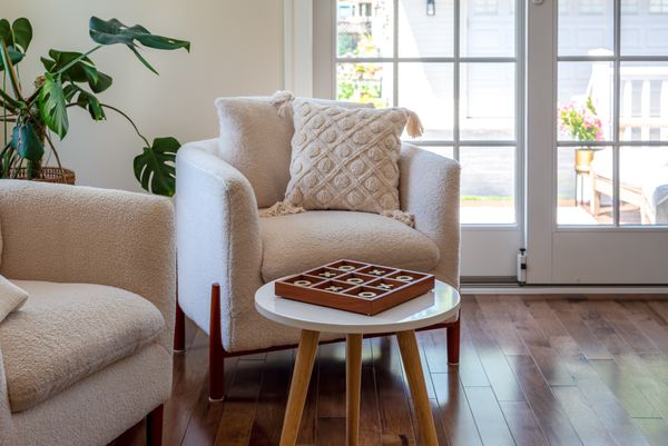A pair of boucle chairs with décor 