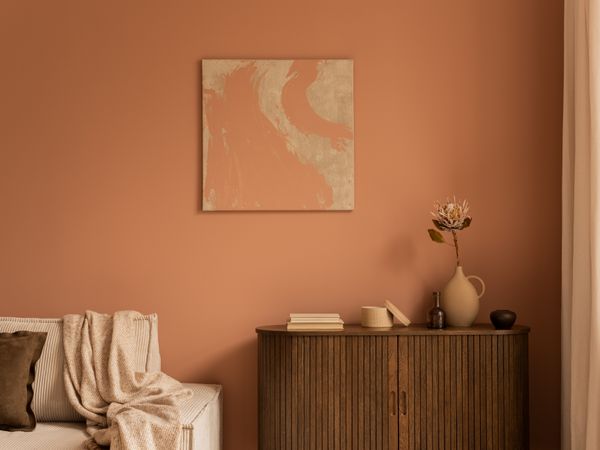 a sepia-tone bedroom featuring a wood console table and beige décor 