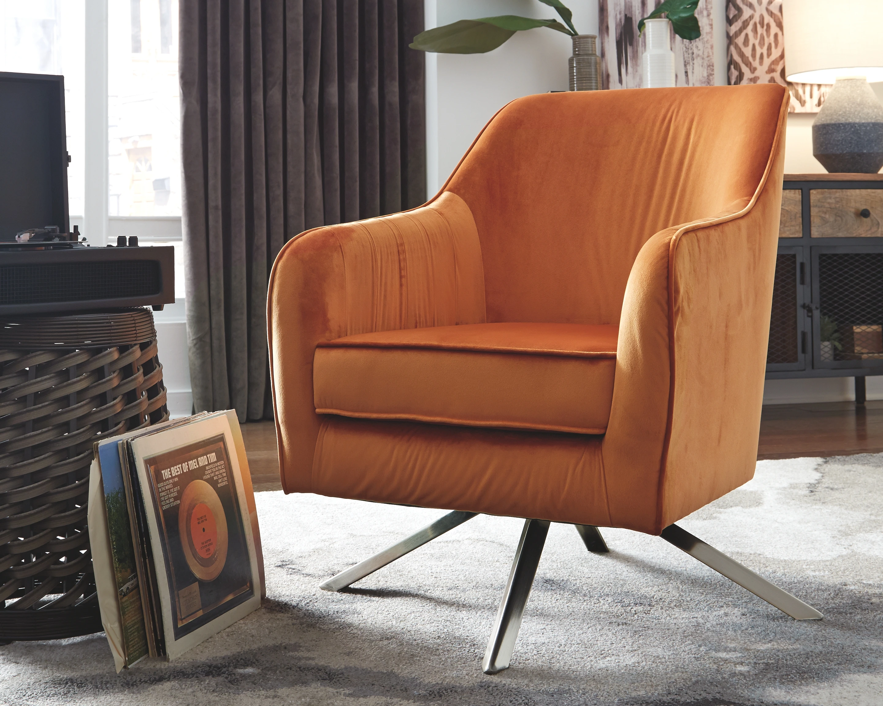 The Signature Design by Ashley Hangar accent chair next to mid-century modern décor 