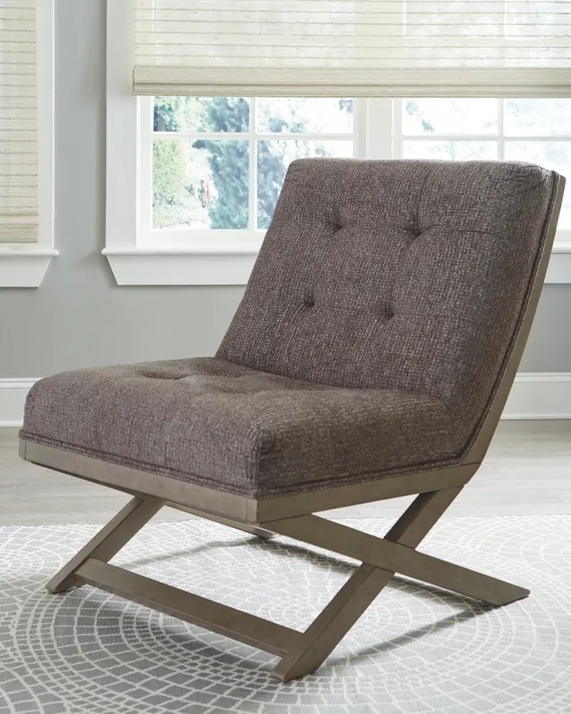 The Signature Design by Ashley Sidewinder accent chair in a living room 