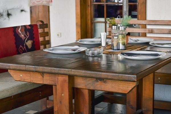 An Amish-style table set with dinnerware and condiments 