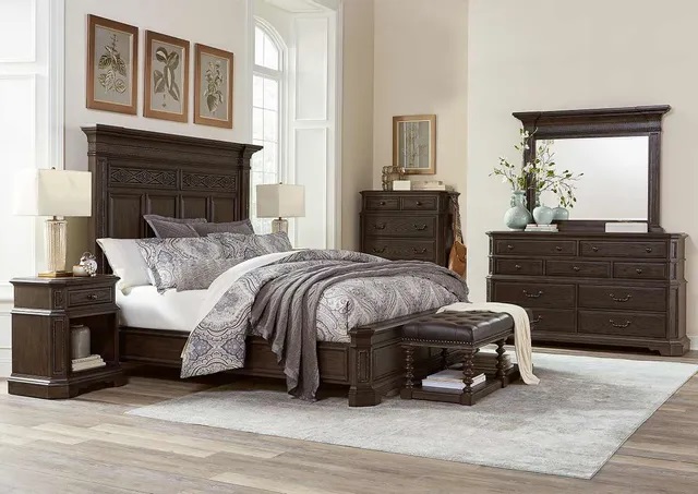 Upscale bedroom with premium wooden furniture pieces and a large mirror. 