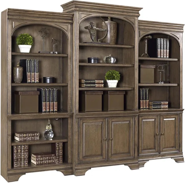 Stock image of a large wooden bookcase filled with books and art pieces. 