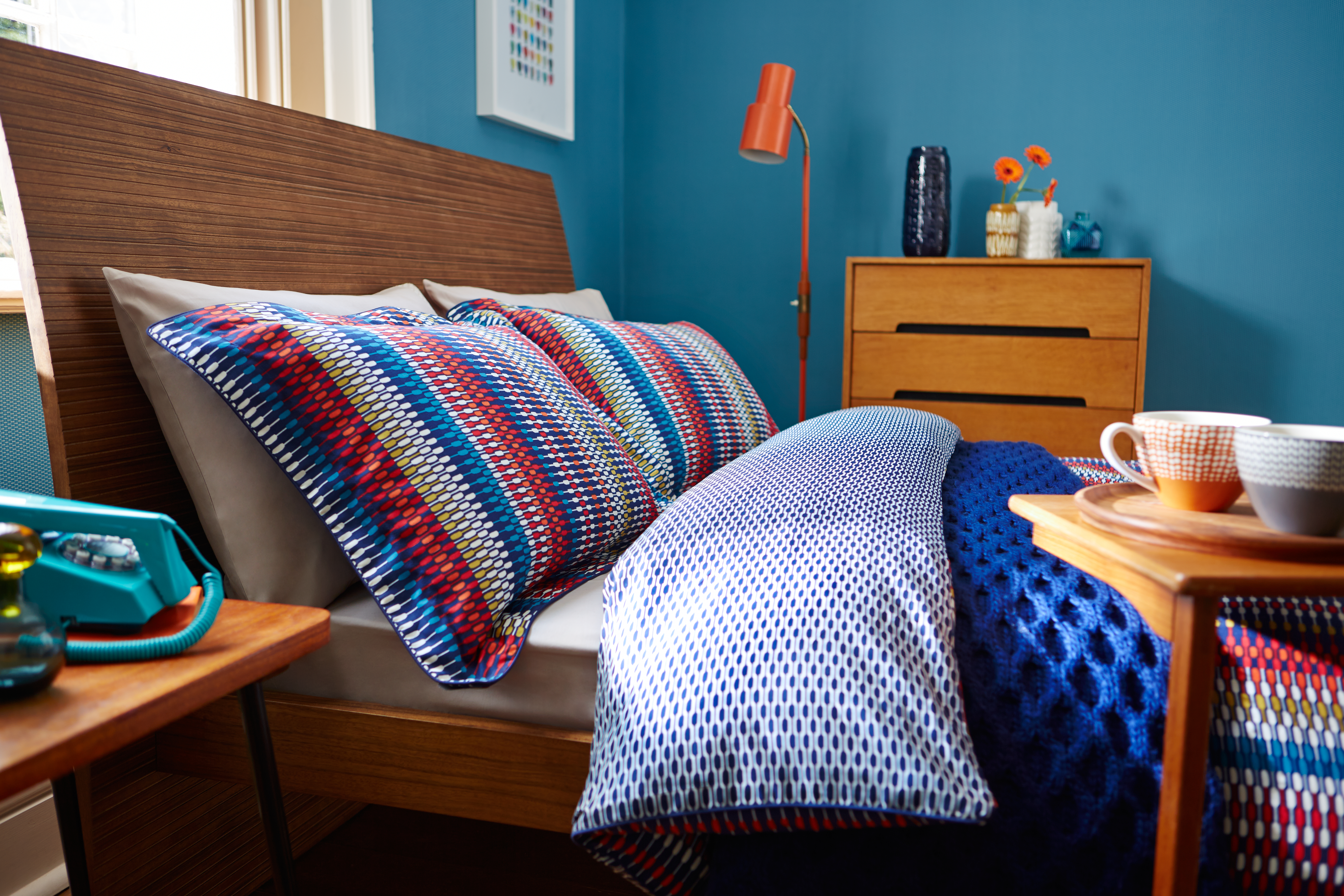 A multicolored bedding set on mattress 