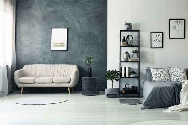 A grey-themed bedroom featuring a sofa 