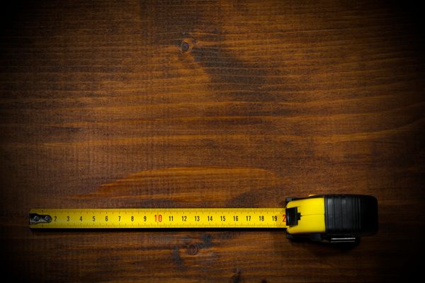 An extended measuring tape on a wooden table 