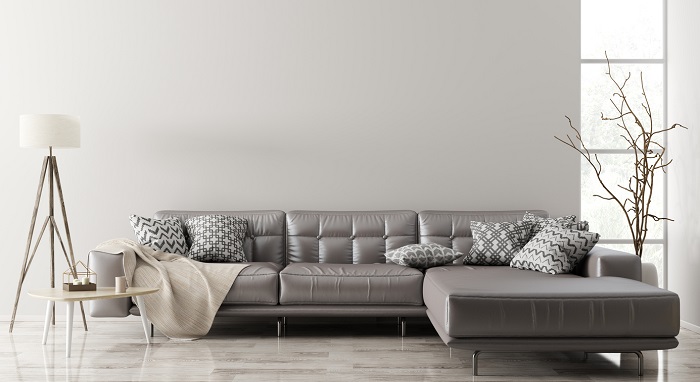 Modern interior of living room with brown leather sectional sofa.