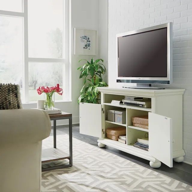 Modern living room with a Flat screen tv stand that’s opened up to show the storage cabinets. 