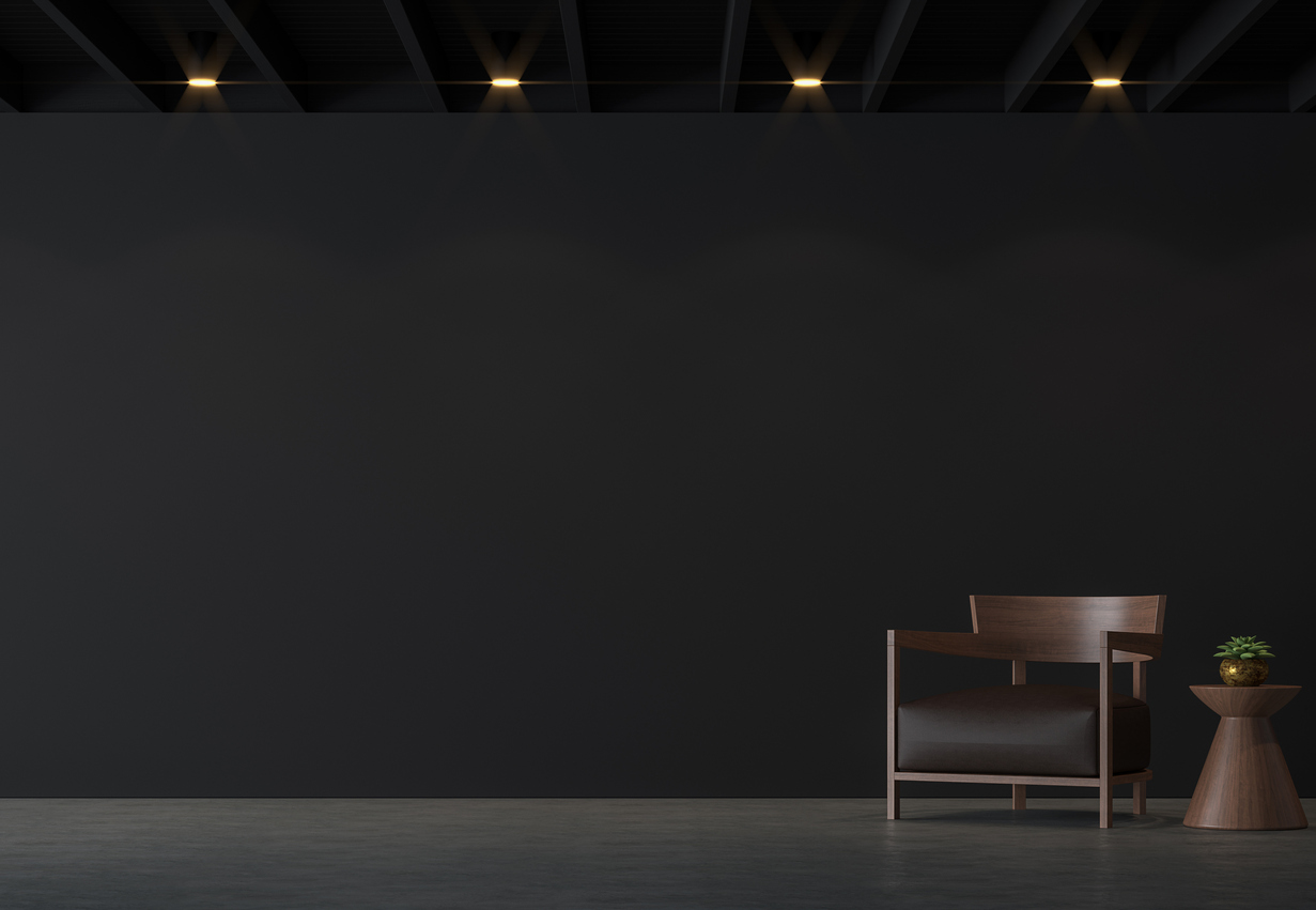 A black and wood accent chair against a black background 