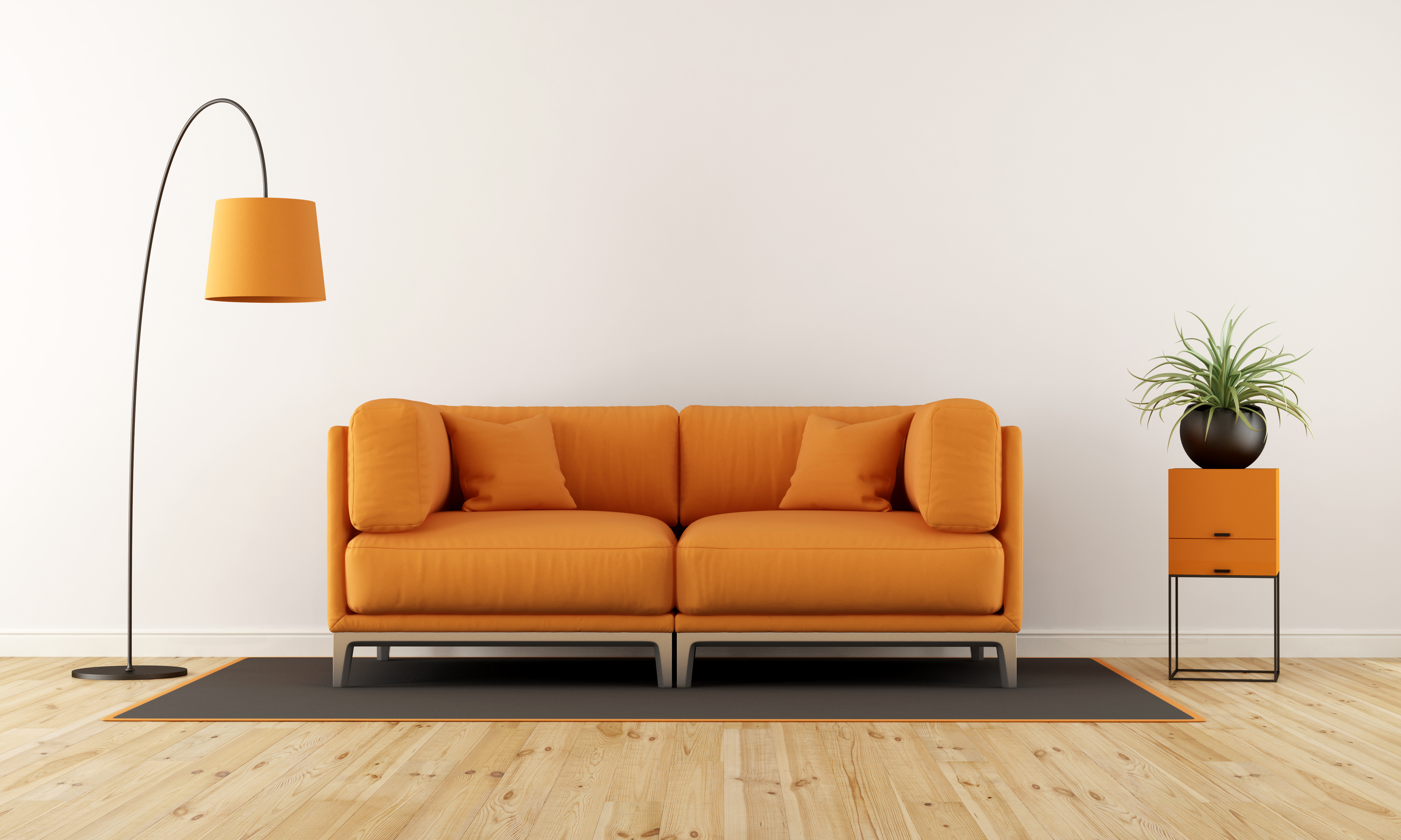 An orange arm sofa with a matching table and lamp 