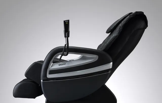 Image of a black Cozzia massage chair in a reclined position. 
