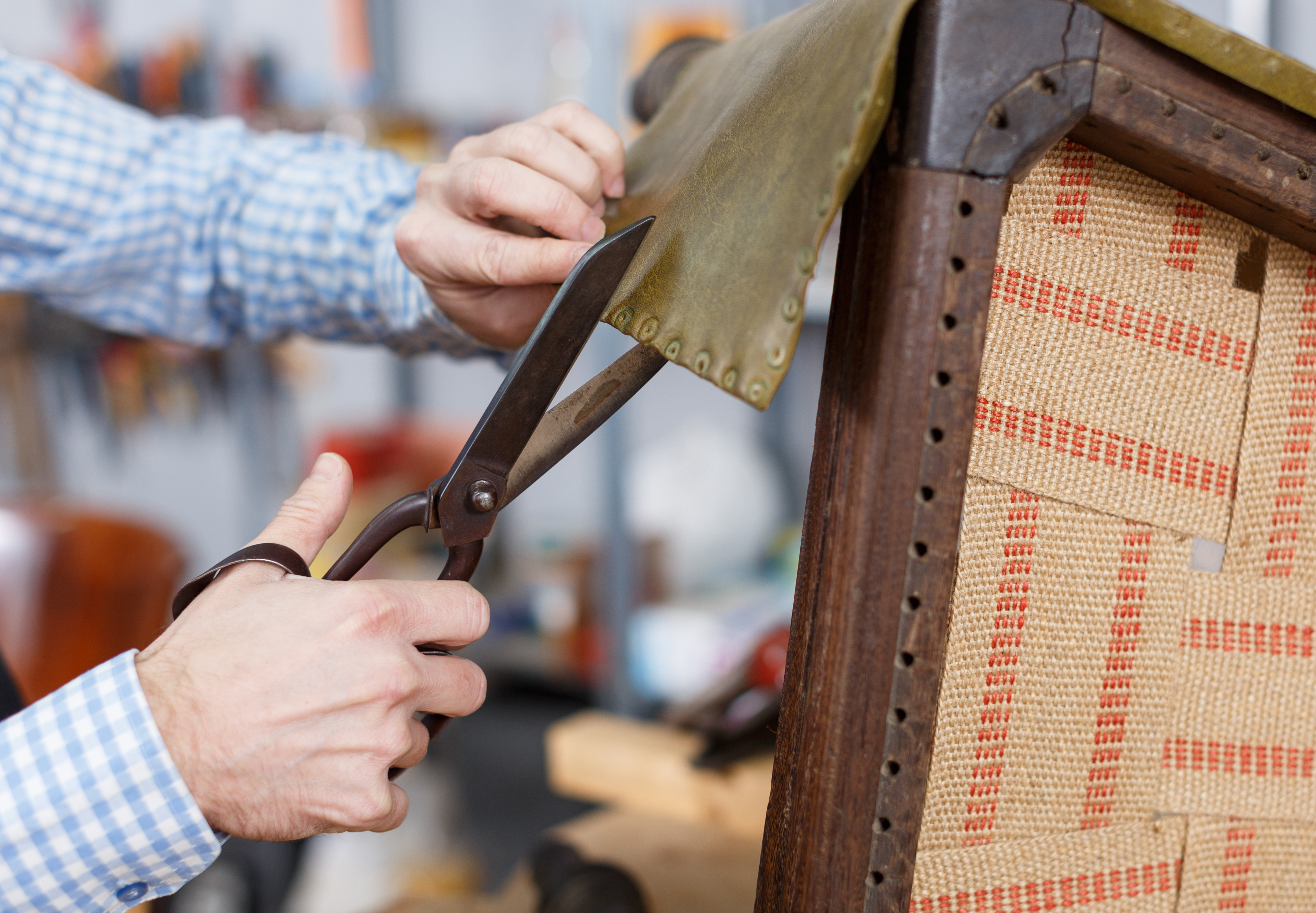 A person upholstering a chair 